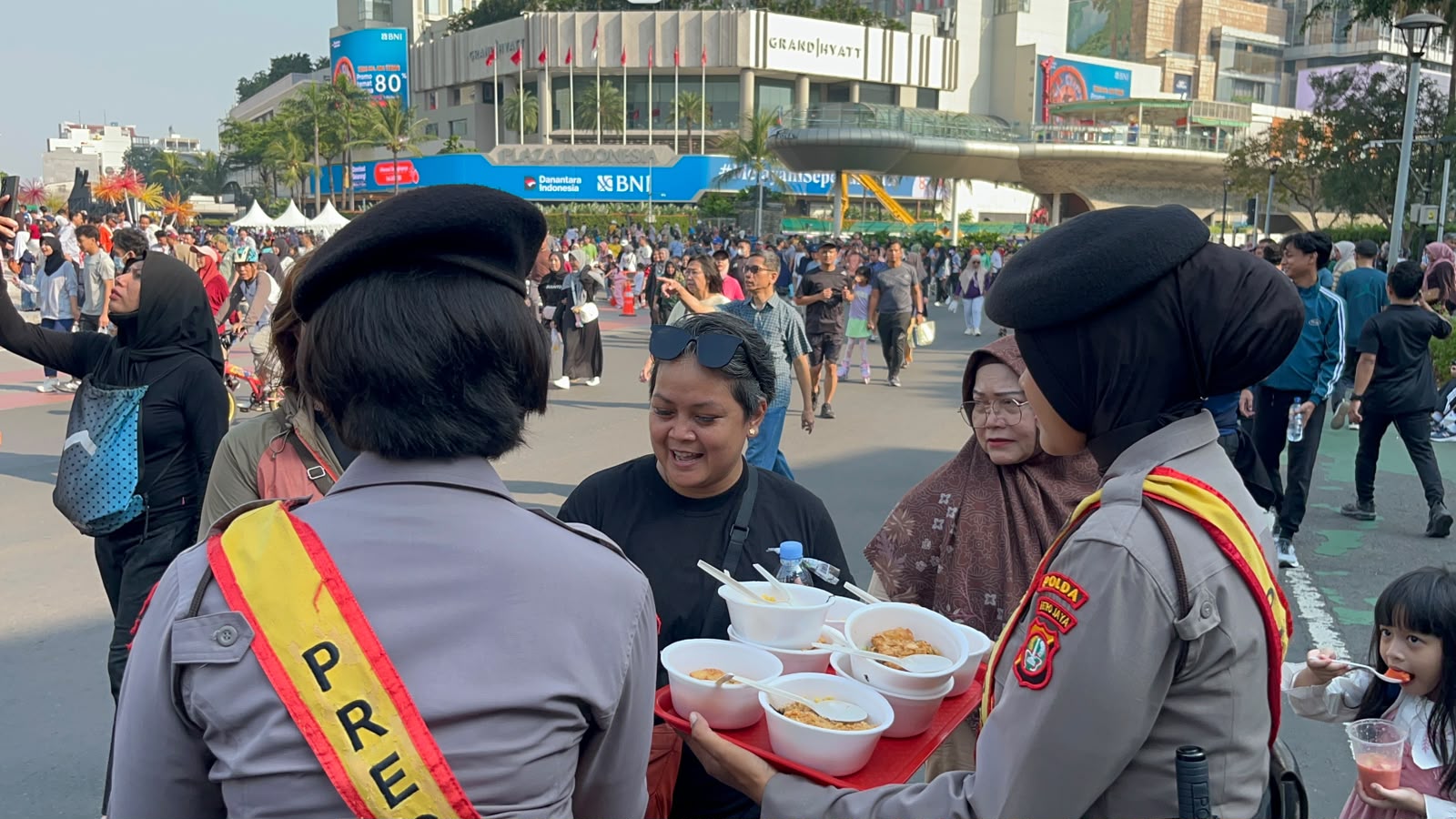 Polda Metro Jaya membagikan ratusan porsi makanan gratis kepada masyarakat di Bundaran HI dalam rangka Hari Bhayangkara ke-80 sebagai bentuk kepedulian kepada warga. (Foto: ReportaseNews/HO-Humas Polda Metro Jaya)